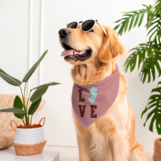 Dog wearing sunglasses and a bandana with LOVE NJ sitting indoors with plants.