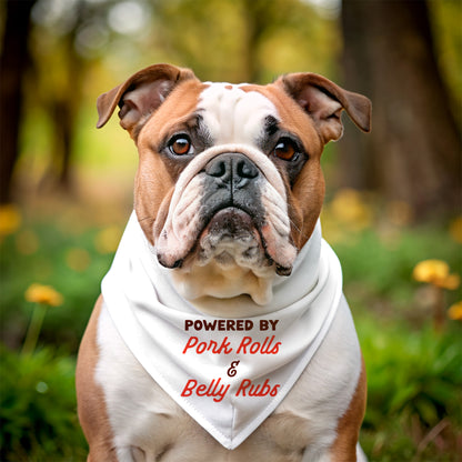 Bulldog wearing a bandana with text 'Powered by Pork Rolls & Belly Rubs' in a natural setting.